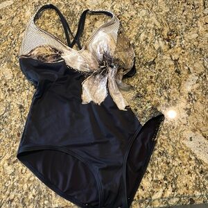 Women’s Vibrabt black and gold one piece with double cross straps.